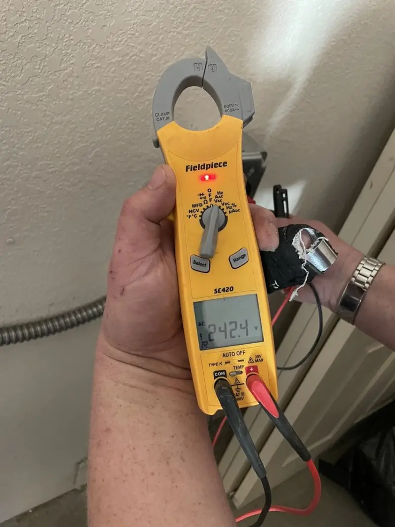 Voltage testing with clamp meter during Ceiling Fan Installation in Winooski